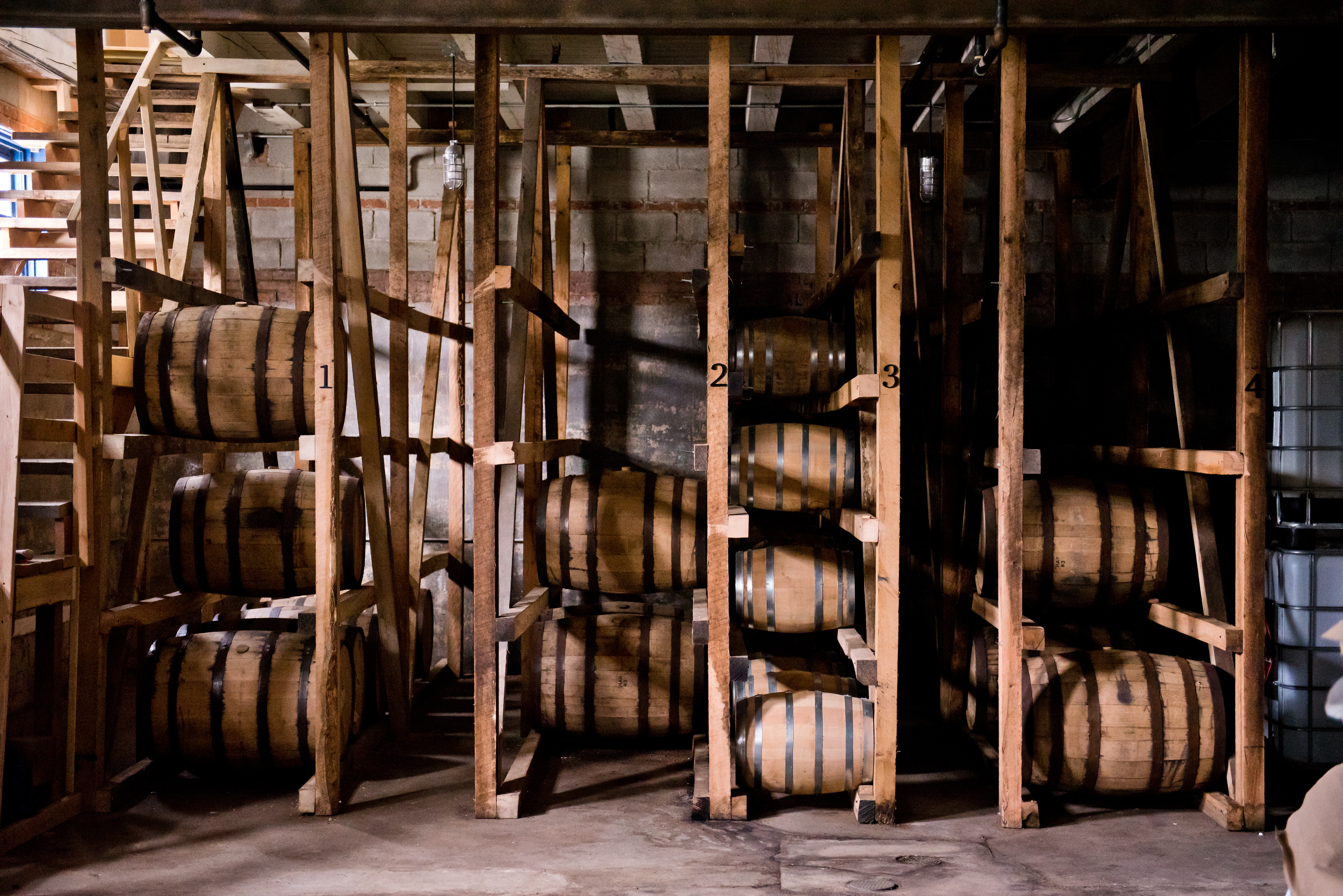 a room with shelves of barrels that hold liquor