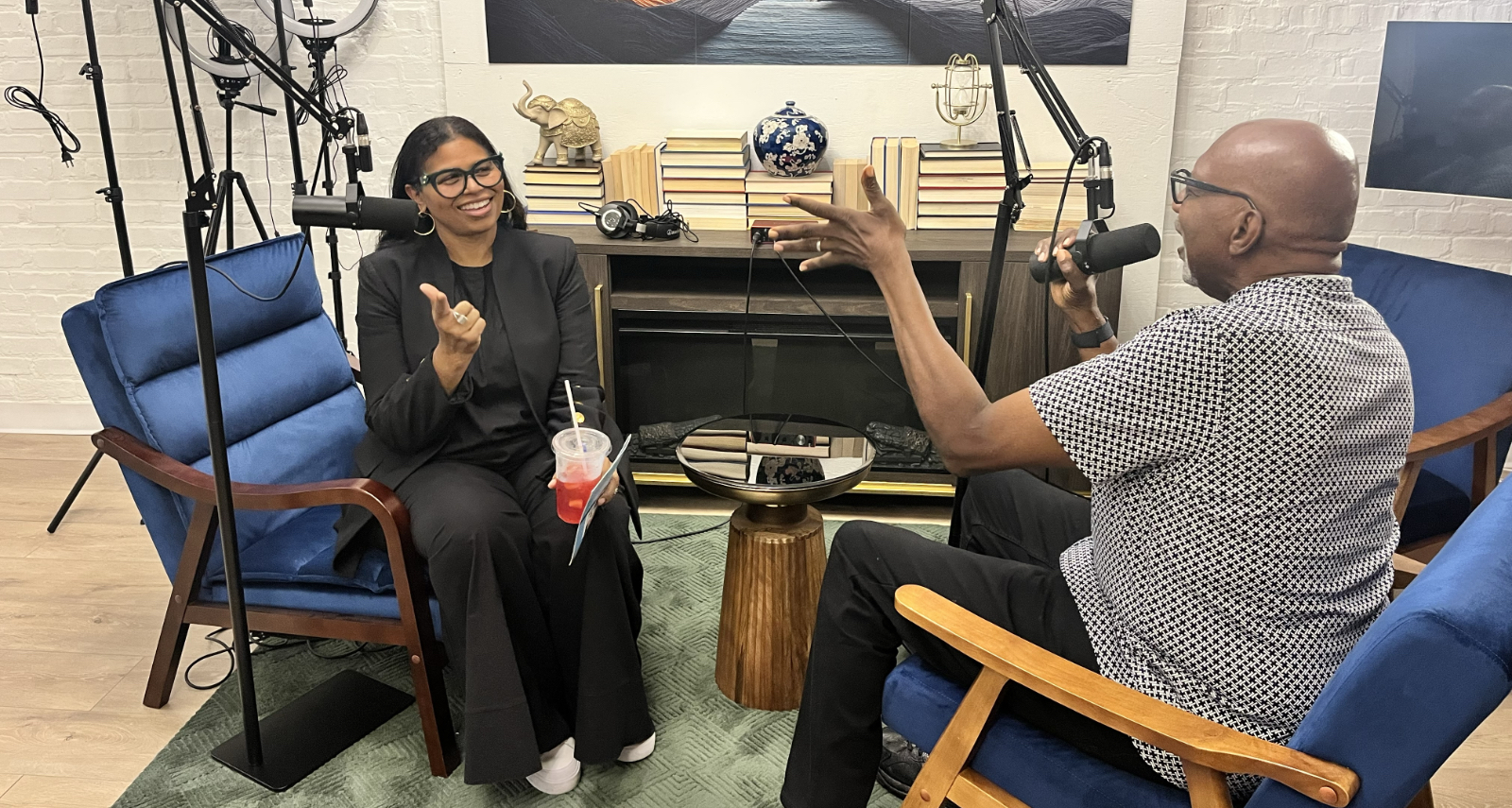 The owner of Beyond The Book and a guest sitting in the podcast studio space. - 