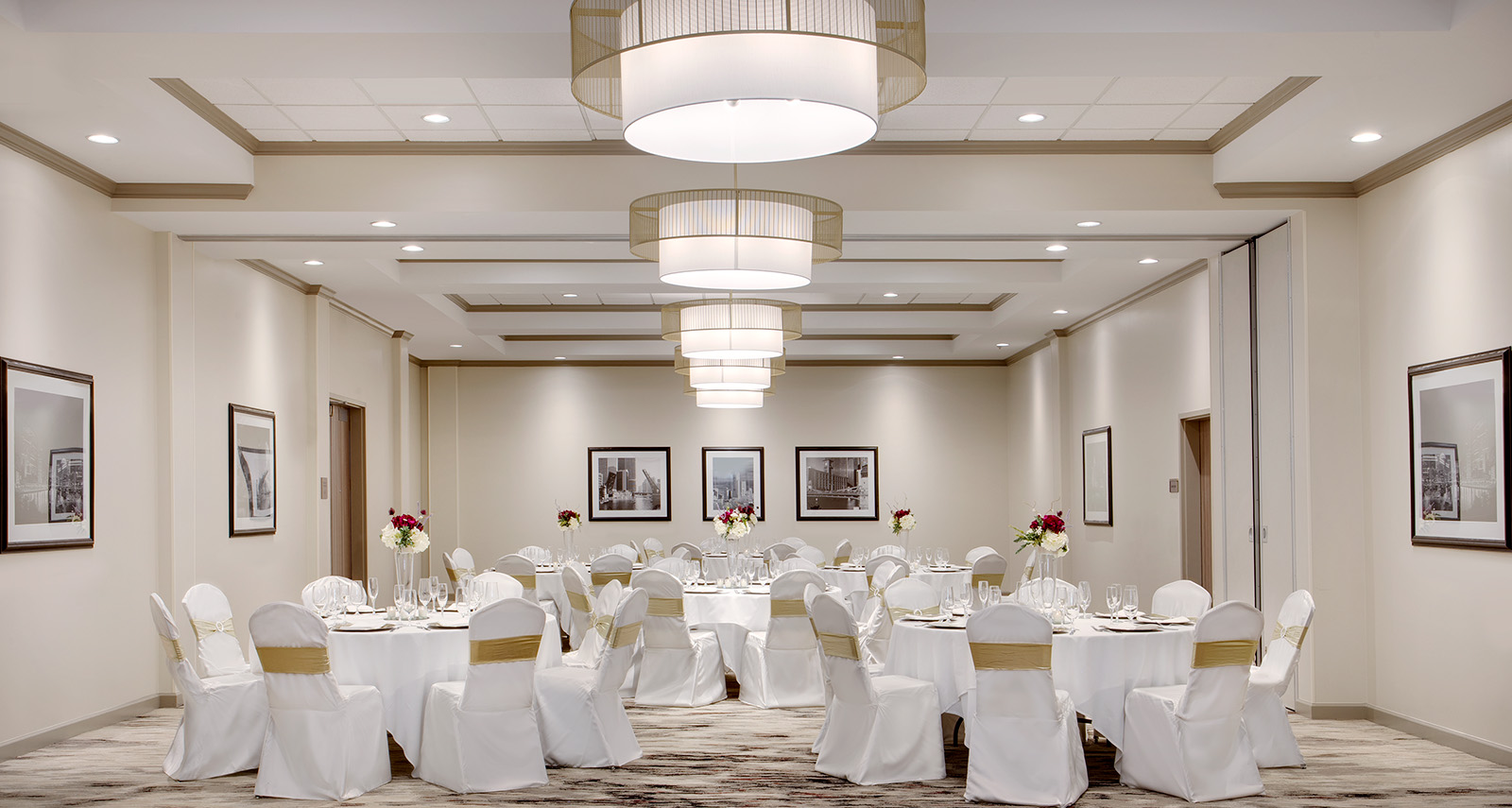ballroom set up with white table cloths and gold accents - 