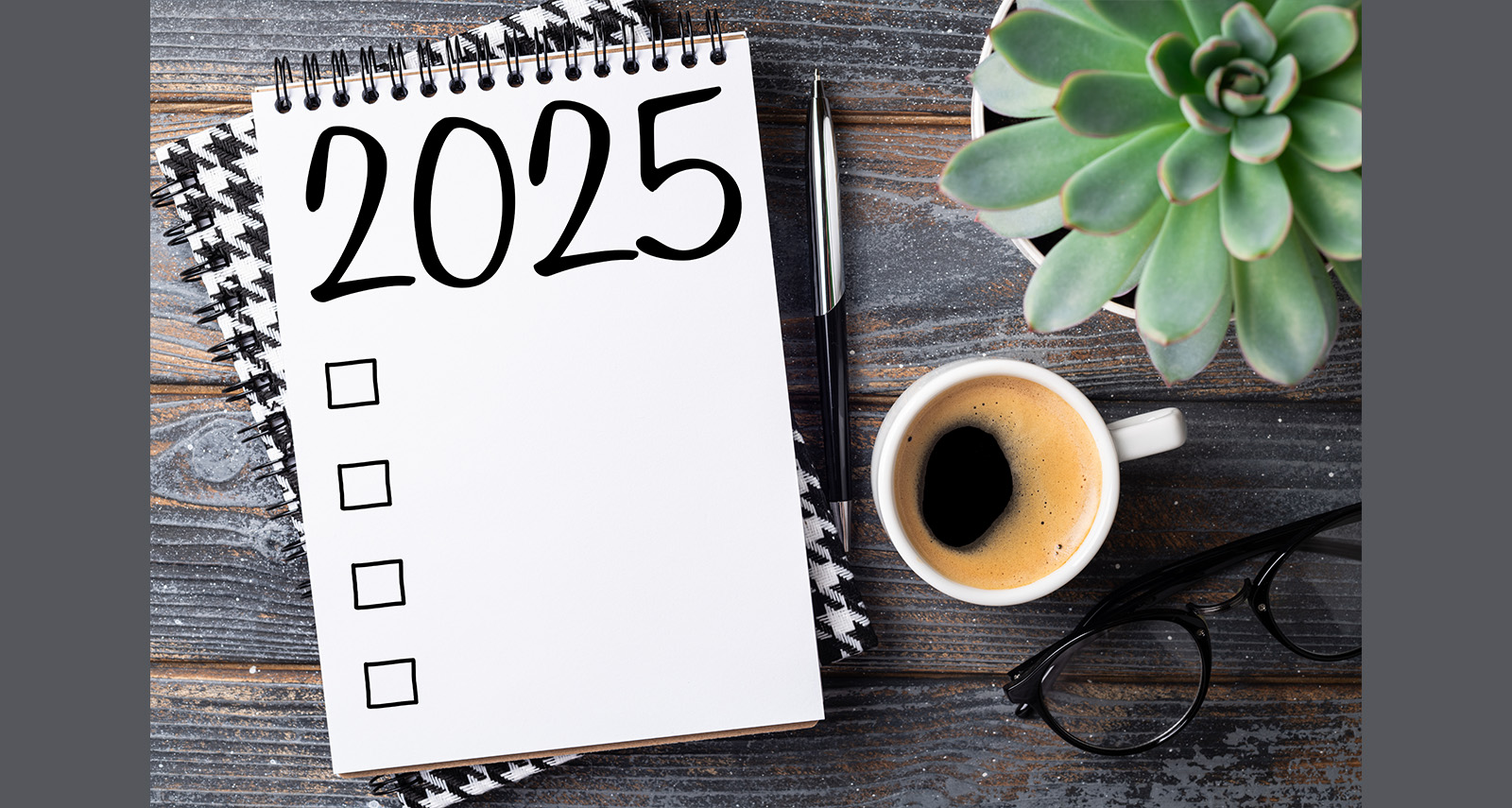 pad of paper for 2025 resolutions alongside a plant and cup of coffee - 
